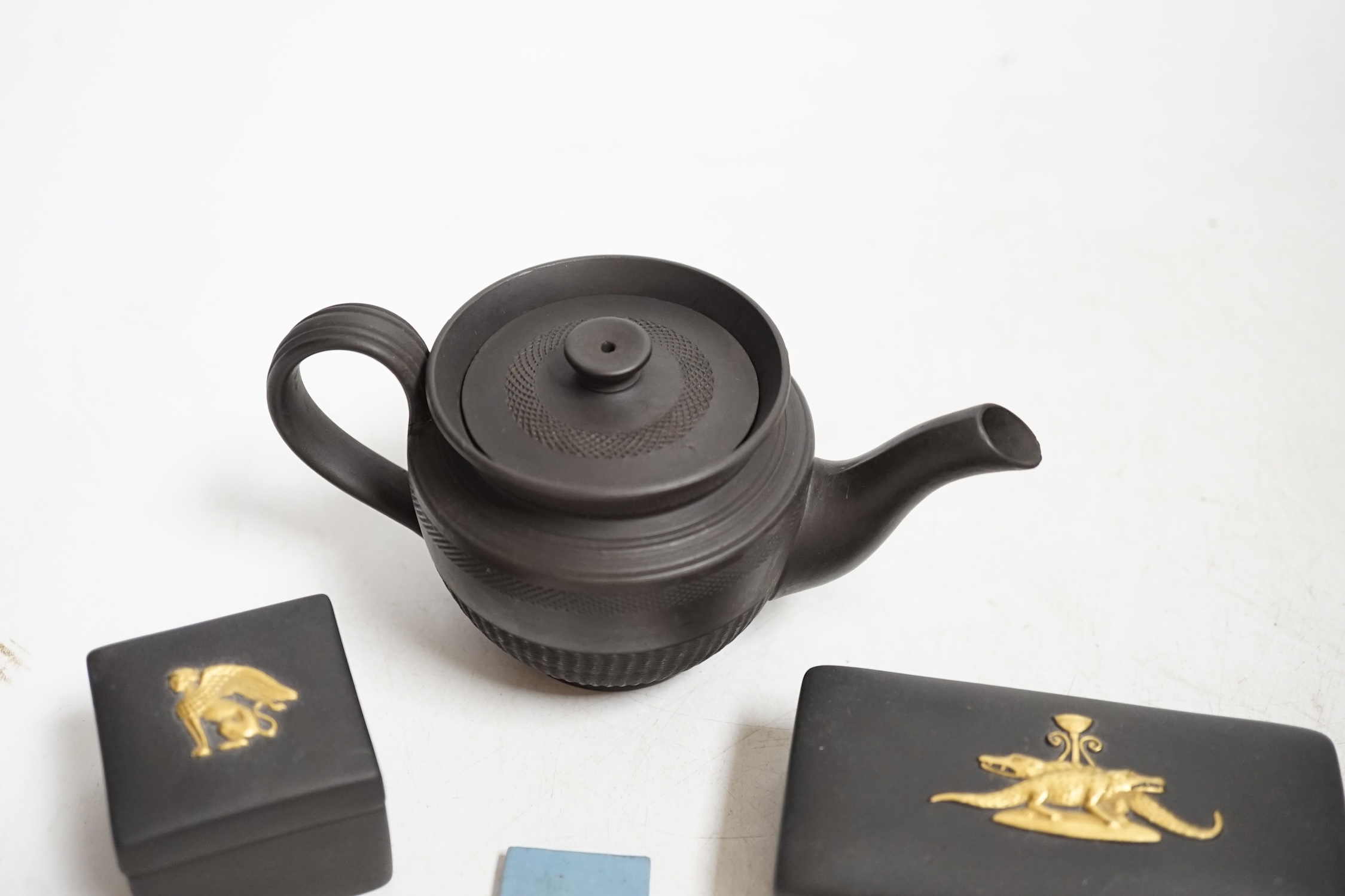 Wedgwood pieces comprising two plaques including a jasperware example and two small boxes, together with a black basalt teapot, largest 14cm wide. Condition - poor to fair